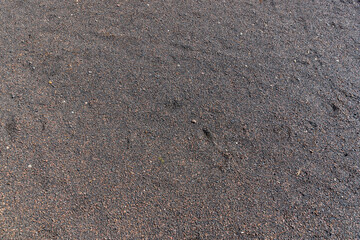 a narrow walking path in the park made of natural finely crushed rubble, not a wide path for pedestrians to walk in the park