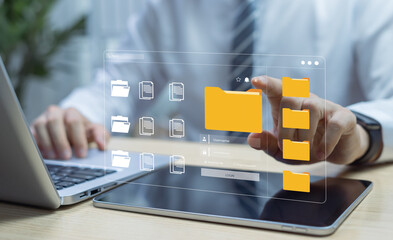 Businessman using tablet for Document Management System DMS, managing business processes with digital security to organize, store, and share corporate documents and files.