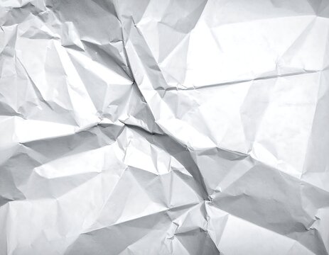 Close-up of wrinkled white paper, creating various angular shadows