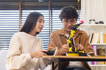 Young couple building robotic arm at home