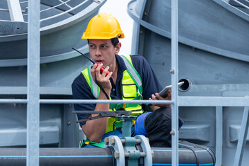 Construction workers coordinating rooftop solar installation