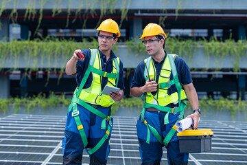 Engineers reviewing solar panel system on rooftop
