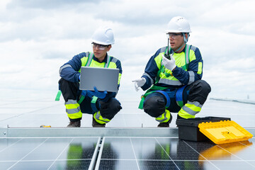 Engineers analyzing solar panel data on rooftop