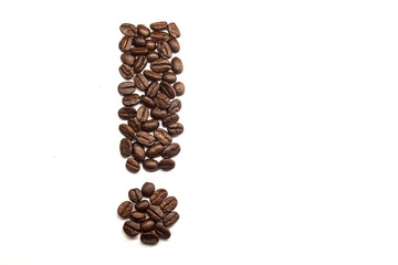 Top view of coffe beans arranged to an exclamation mark, isolated on white background