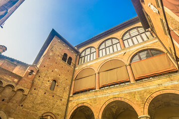Obraz premium Photo of a typical building facade in Siena old town showing medieval stone and brick architecture, rustic windows with shutters and authentic Tuscan atmosphere in Italy