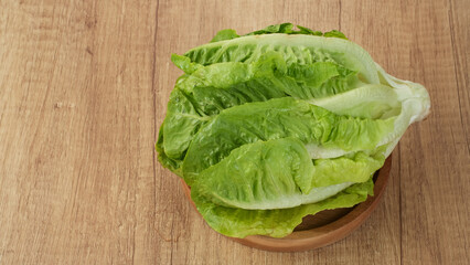 Fresh green romaine lettuce on a wooden background