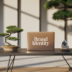 A laptop displays Brand Identity next to a bonsai tree and a crystal on a modern desk