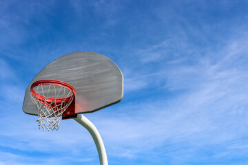 Basketball hoop on blue sky background with copy space.