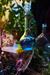 vibrant blue potion sits in a glass bottle, surrounded by green plants and soft candlelight. Smoke gently swirls around a mystical scene, creating an enchanting atmosphere