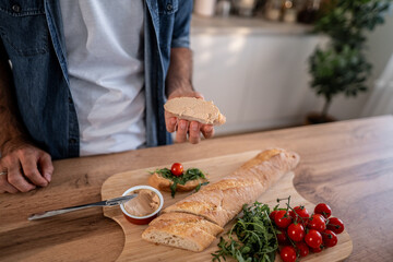 Person holding baguette slice with pate spread