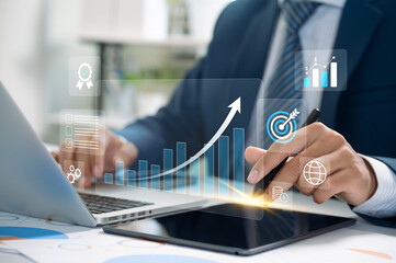 Businessman analyzing profit growth using digital tablet in modern office, focusing on quality management, cost control, and financial planning for company success in a competitive economy