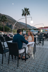 Happy couple enjoying delicious food at an open buffet restaurant during holiday.