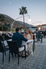 Happy couple enjoying delicious food at an open buffet restaurant during holiday.