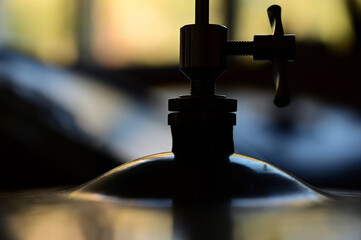 Silhouette of a cymbal at close range