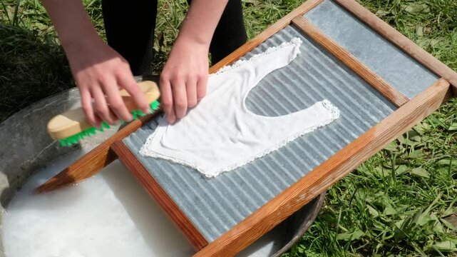 Washing clothes with curd soap on an old-fashioned washboard