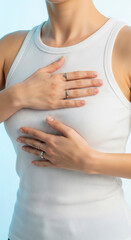 Woman's hands check her breasts. A portrait emphasizing awareness and care. Breast cancer awareness, self-examination, early detection. World Breast Cancer Day