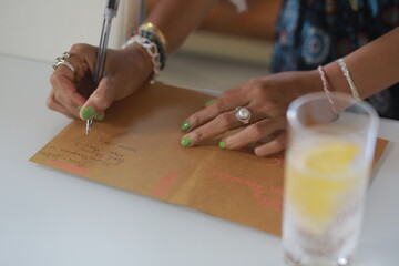 Woman Writing Wishes in a Holiday Greeting Card