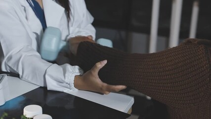 Asian older aged woman doing physiotherapist with support from nurse or doctor.caregiver or personal trainer helping Elderly patient using dumbbells in weightlifting.nursing home,wellness at home - Powered by Adobe