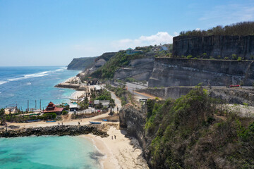 Winding mountain roads carved into white cliffs descending to the ocean