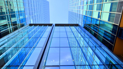 Bottom up view of  modern glass office building. Commercial real estate. New commercial office building in modern city.