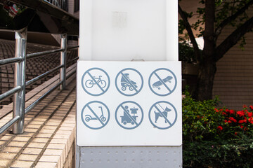 White signs icon symbol plate with man icon for No cycling, no skateboarding, no electric scooters, Do not bring pets. Warning of prohibited areas playing various devices. Regulations must be followed