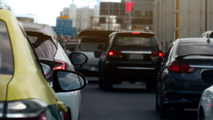 Blurred rear side car of yellow taxi and to focus to tail light of white car on the asphalt. Many...