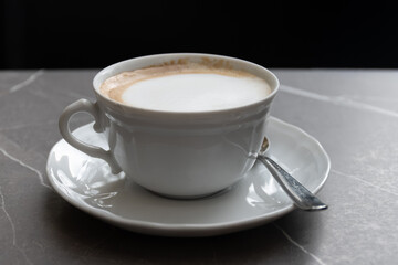 White cup of italian coffee cappuccino served in cafe in Milano, Italy