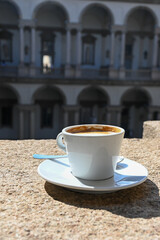 Drinking of italian coffee cappuccino served in museum and castle cafe in Milan, Italy
