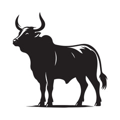 Silhouette of a majestic bull with prominent horns standing on a grassy field