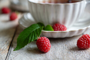 For breakfast, there are toasts with fruits and berries and a cup of aromatic tea on the table.