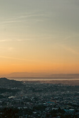 Sunset Overlooking Cityscape and Distant Mountains