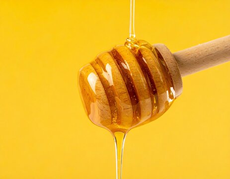 Honey dripping from a wooden dipper - Powered by Adobe