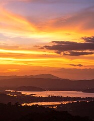 Panoramic sunset over mountains and lake