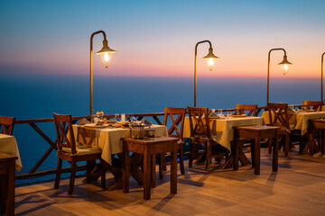 A cozy, romantic atmosphere in a restaurant as the sun sets.

