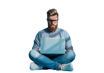 A bearded man with glasses sits crosslegged on the floor, intently focused on his laptop, isolated on transparent background