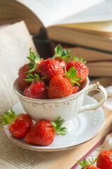 Delicate pancakes with fruits and berries on a wooden table.
