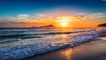 sunrise over the ocean with waves lapping the shore