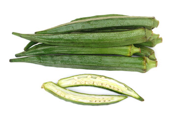Fresh green okra pods with one sliced open to show seeds, isolated on white background. Nutritious organic vegetable often used in cooking, herbal remedies, and healthy diet recipes.