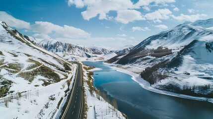 Snowy mountain road by lake