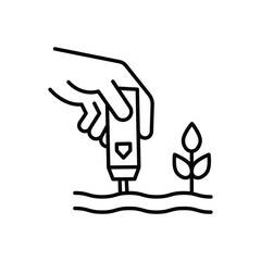 A hand holds a soil tester near a small plant in a garden