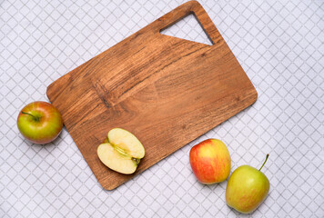 Wooden board with apples on clean surface, leaving copy space for text or branding. Ideal for food advertising, recipe websites, organic product packaging, and modern food branding projects.