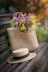 Wild flowers in a beautiful straw bag and a straw hat.