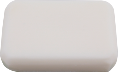 A simple white bar of soap in rounded rectangle shape lying on a white surface PNG cutout transparent background isolated