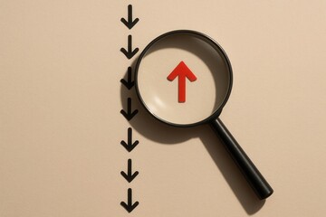 An upward red arrow inside a magnifying glass is contrasted with downward black arrows arranged in a line against a soft, neutral background, symbolizing a shift in direction or focus.