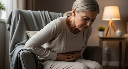 Obraz premium Elderly Woman Experiencing Abdominal Pain.