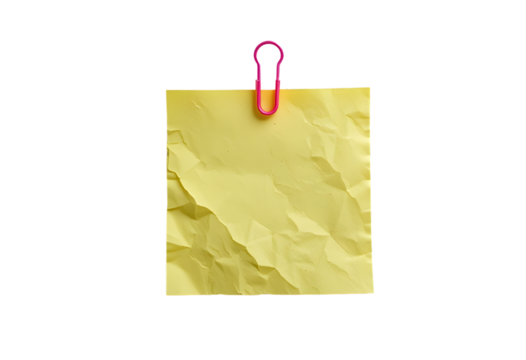 A crumpled yellow sticky note held by a pink paperclip, isolated on a white background with ample copy space for text or a message