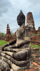 Fototapeta premium Wat Chaiwatthanaram in Ayutthaya, Thailand. Scenic ruins of the Buddhist temple in the ancient city. Parts of Buddha statues.