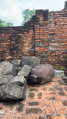 Wat Chaiwatthanaram in Ayutthaya, Thailand. Scenic ruins of the Buddhist temple in the ancient city. Parts of Buddha statues.