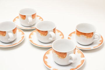 Elegant Coffee or Tea Cups with Ornamental Design Isolated on White Background, ready for a refreshing hot beverage