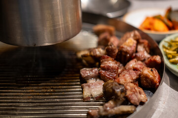 Samgyupsal, a popular Korean dish consisting of thick, sliced pork belly cooked on the grill